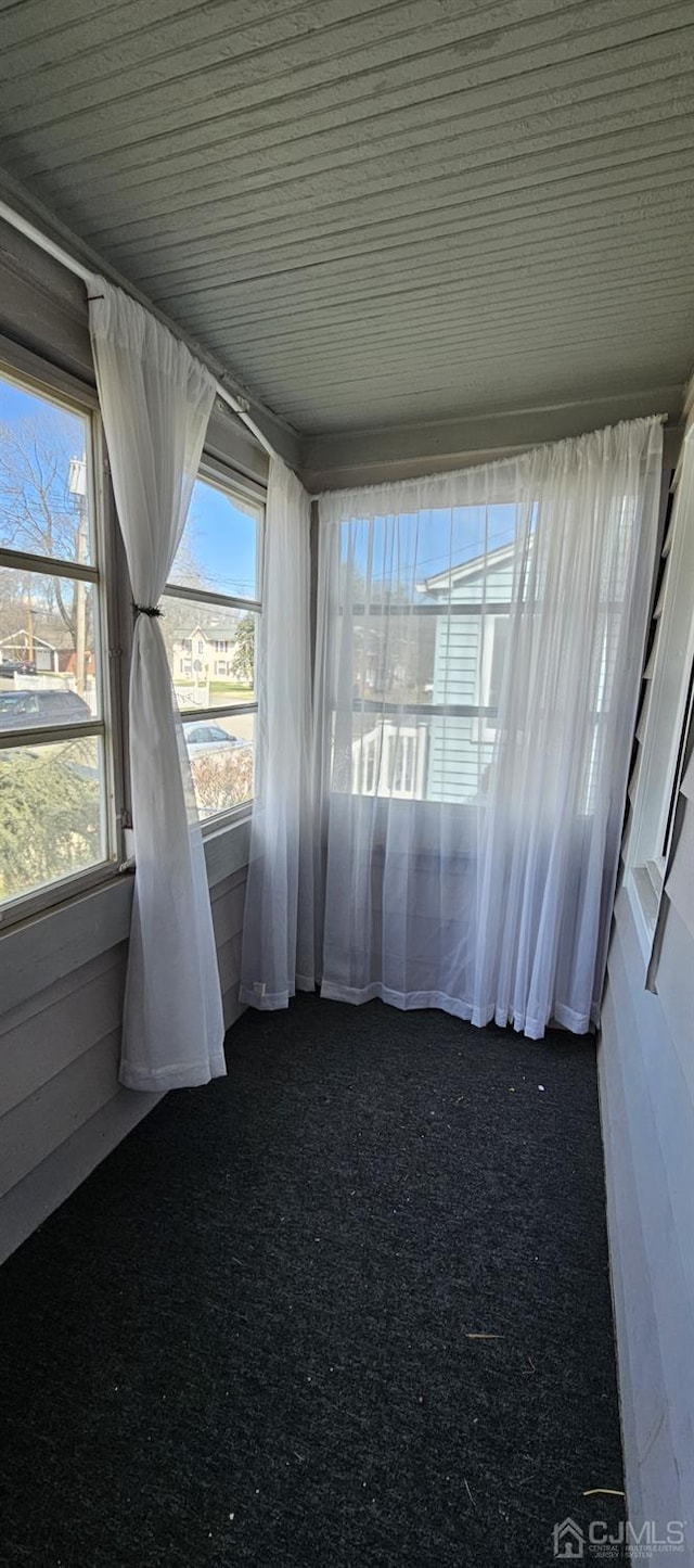 unfurnished sunroom featuring wooden ceiling