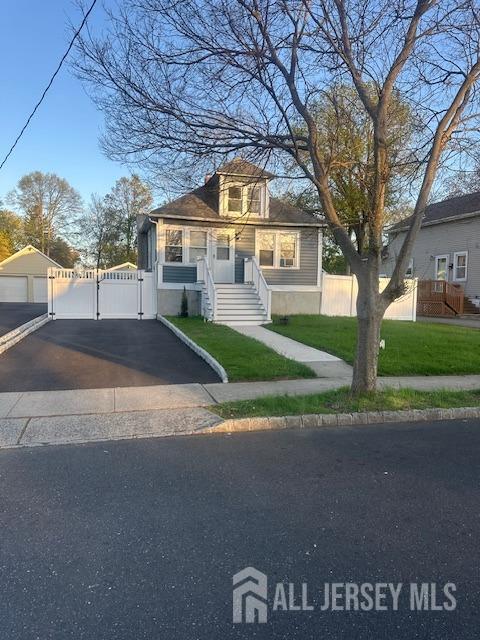 bungalow with a gate, fence, and a front yard