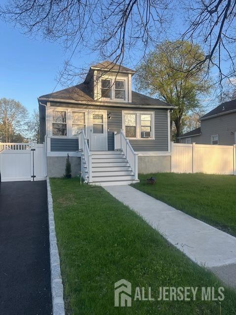 bungalow-style home featuring fence, a gate, and a front yard