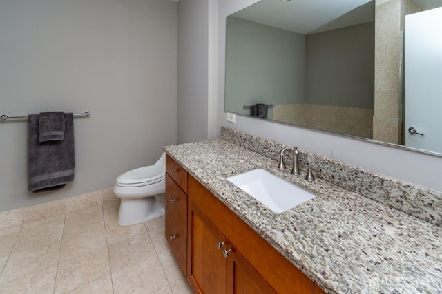 bathroom featuring vanity, tile patterned floors, and toilet