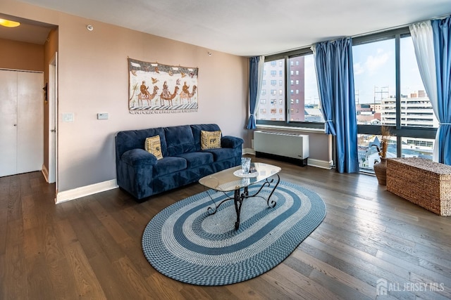 living room with radiator and dark wood-type flooring