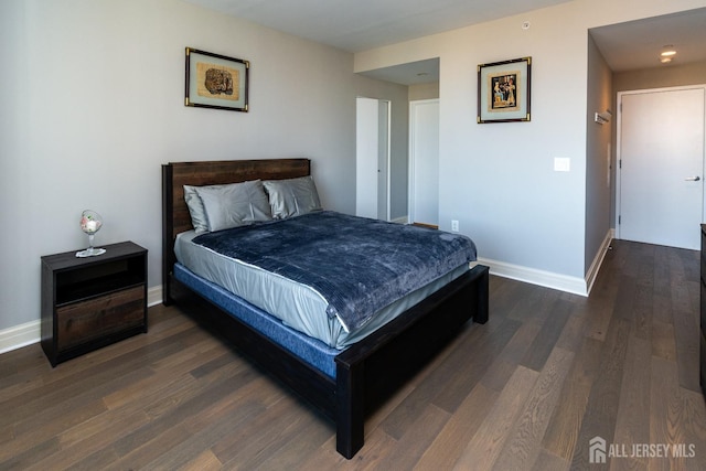 bedroom with dark hardwood / wood-style flooring