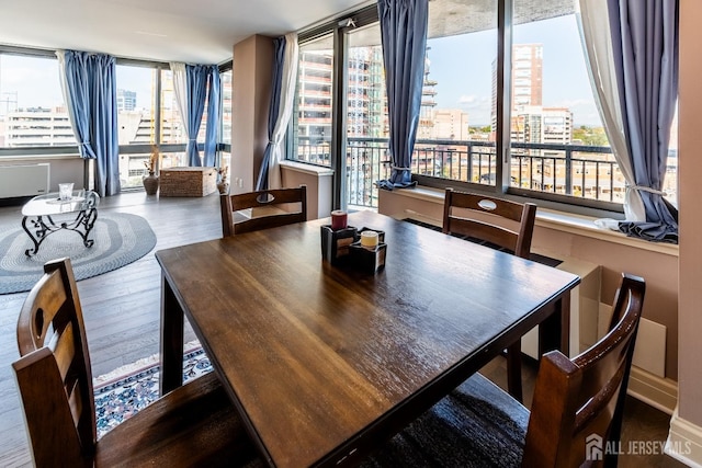 dining area with hardwood / wood-style flooring and a healthy amount of sunlight