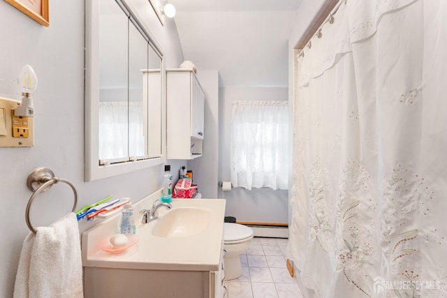 bathroom with a baseboard heating unit, toilet, vanity, and plenty of natural light