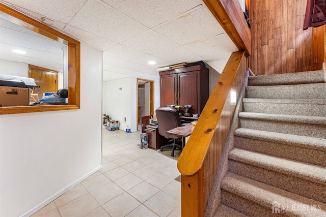 stairs featuring recessed lighting, a drop ceiling, tile patterned flooring, and baseboards