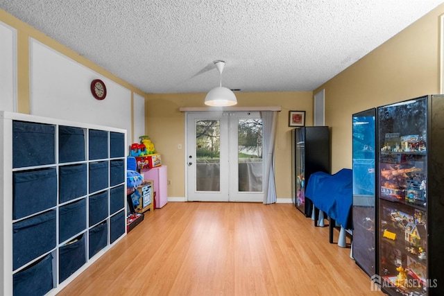 8 Carlisle Ct, Old Bridge, NJ 08857 - recreation room with a textured ceiling, wood finished floors, and baseboards