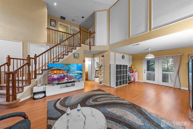 8 Carlisle Ct, Old Bridge, NJ 08857 - living room featuring wood finished floors, stairs, baseboards, french doors, and a high ceiling