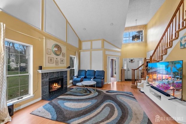 8 Carlisle Ct, Old Bridge, NJ 08857 - living room with a towering ceiling, wood finished floors, a tiled fireplace, and stairway