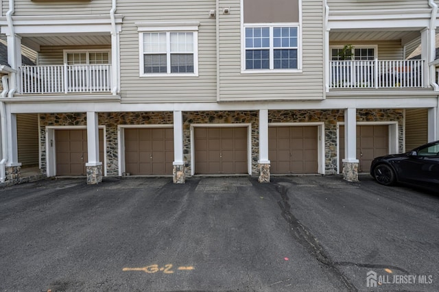23 Newburgh Dr, Edison, NJ 08820 - rear view of house featuring stone siding and a garage