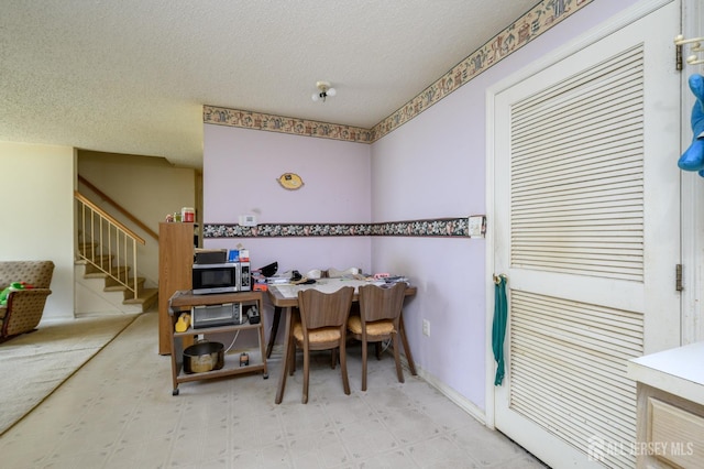 23 Newburgh Dr, Edison, NJ 08820 - dining room with a textured ceiling, stairway, and tile patterned floors
