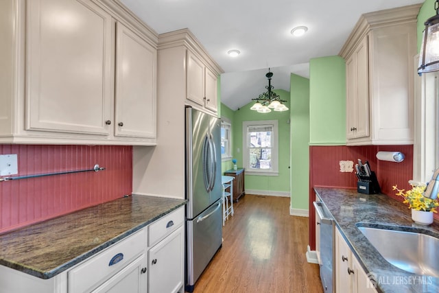 1135 Dorsey Pl, Plainfield, NJ 07062 - kitchen with stainless steel appliances, a sink, light wood finished floors, baseboards, and decorative backsplash
