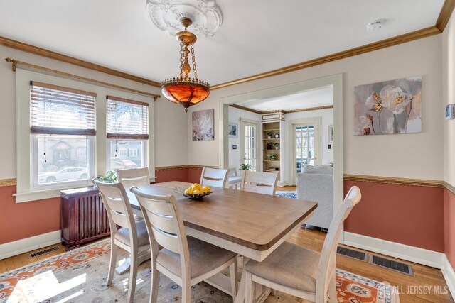 1135 Dorsey Pl, Plainfield, NJ 07062 - dining room featuring baseboards, crown molding, and light wood finished floors