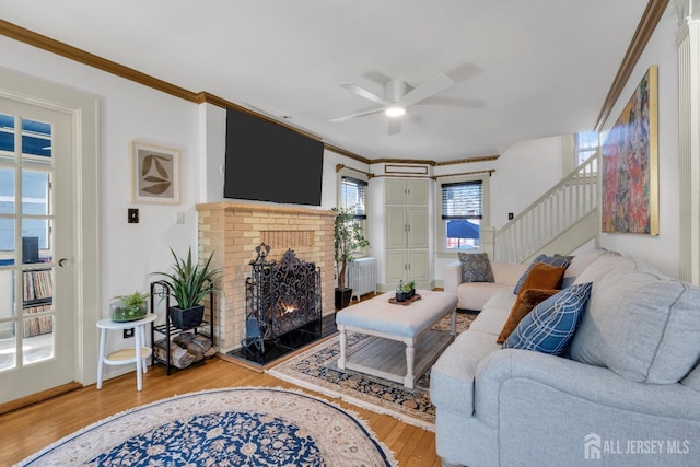 1135 Dorsey Pl, Plainfield, NJ 07062 - living room featuring a ceiling fan, wood finished floors, stairway, ornamental molding, and a fireplace