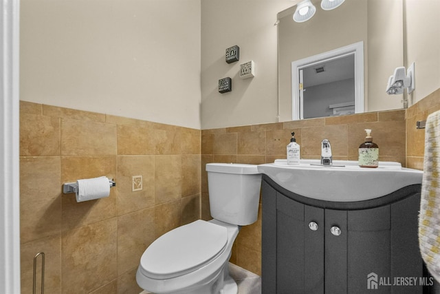 80 Sonora Ave, Iselin, NJ 08830 - bathroom with tile walls, vanity, toilet, and wainscoting