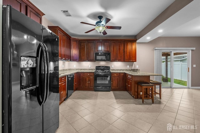 80 Sonora Ave, Iselin, NJ 08830 - kitchen with black appliances, a peninsula, a ceiling fan, light tile patterned floors, and a kitchen breakfast bar