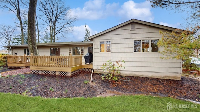 back of property with a deck