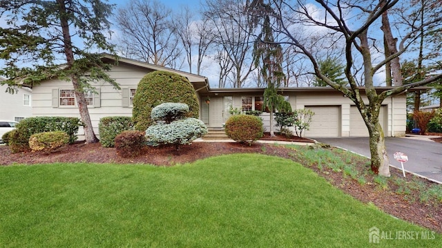 view of front facade with an attached garage, a front yard, and concrete driveway