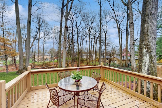 wooden terrace featuring outdoor dining space