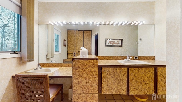 bathroom with two vanities and a sink