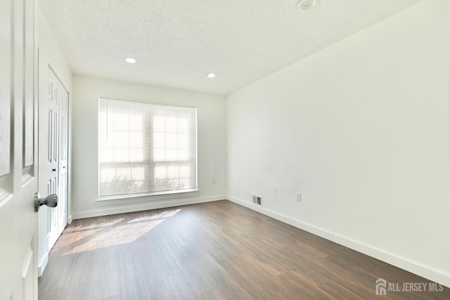 33 Rachel Ct, Franklin Twsp, NJ 08823 - spare room with dark wood finished floors, a textured ceiling, baseboards, and recessed lighting