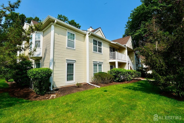 33 Rachel Ct, Franklin Twsp, NJ 08823 - back of property with a chimney and a lawn