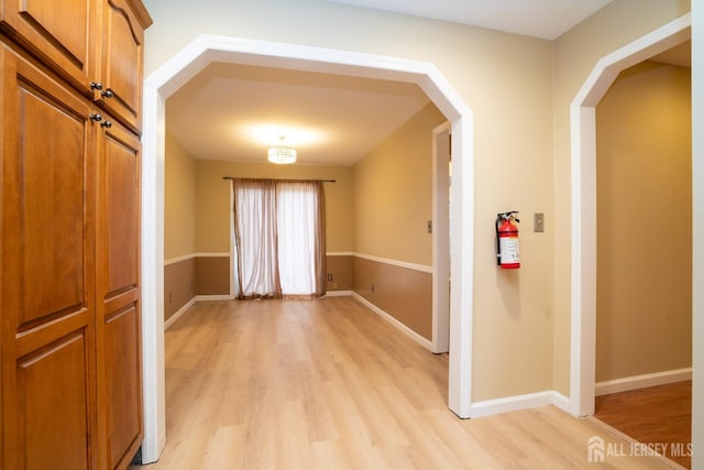 314 Benjamin Ave, Iselin, NJ 08830 - hall with light wood-style flooring and arched walkways
