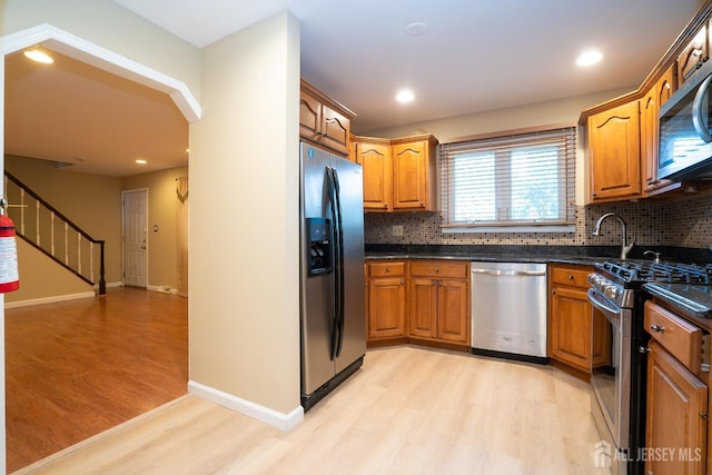 314 Benjamin Ave, Iselin, NJ 08830 - kitchen featuring appliances with stainless steel finishes, light wood finished floors, backsplash, brown cabinets, and recessed lighting