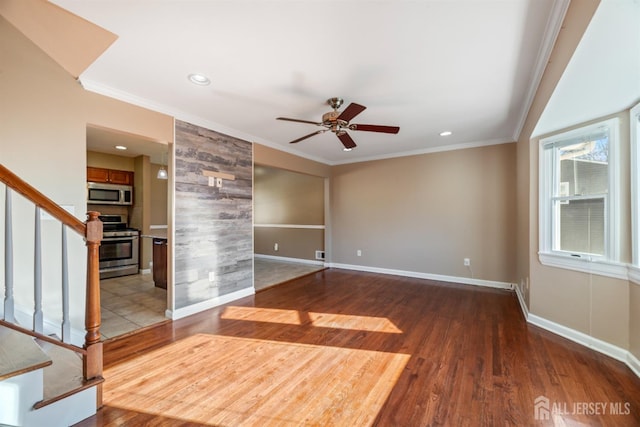 unfurnished living room with ceiling fan, wood-type flooring, and crown molding