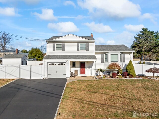 tri-level home featuring a front lawn and a garage