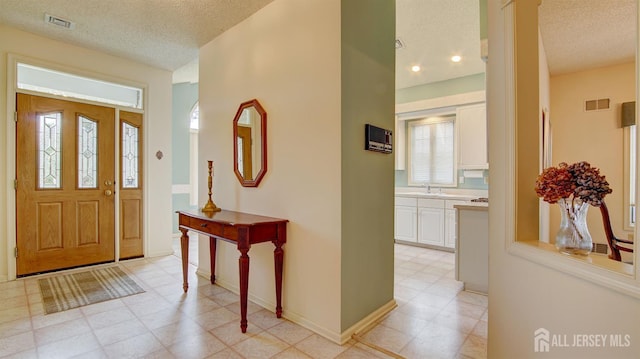 39 Leeds Ln, Monroe, NJ 08831 - entryway with a textured ceiling, light floors, and baseboards