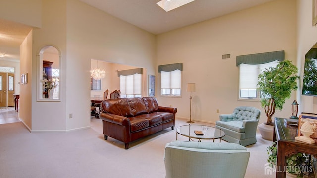 39 Leeds Ln, Monroe, NJ 08831 - living room featuring baseboards, carpet floors, a towering ceiling, and a chandelier