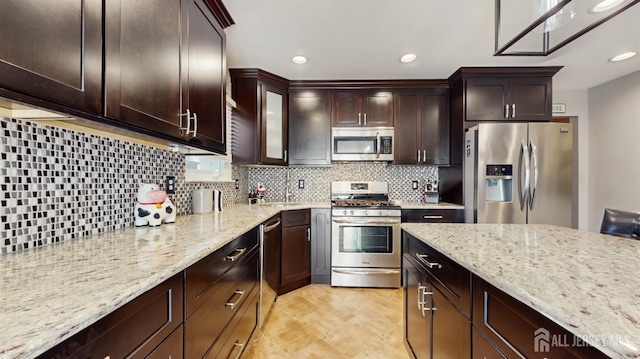 9 Helene St, Old Bridge, NJ 08857 - kitchen featuring appliances with stainless steel finishes, decorative backsplash, light stone counters, dark brown cabinetry, and recessed lighting