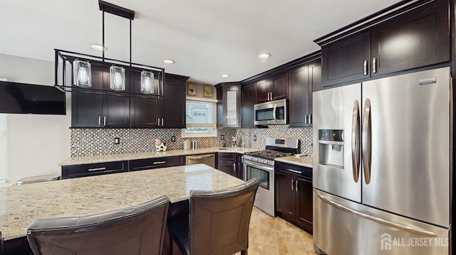 9 Helene St, Old Bridge, NJ 08857 - kitchen with stainless steel appliances, backsplash, light stone counters, decorative light fixtures, and dark brown cabinetry