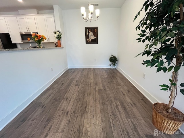 812 Stiller Ln, Monroe, NJ 08831 - unfurnished dining area with dark wood-style flooring, baseboards, and a chandelier