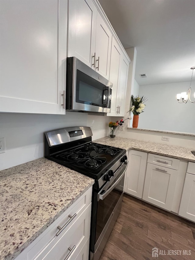 812 Stiller Ln, Monroe, NJ 08831 - kitchen featuring stainless steel appliances, dark wood-style flooring, white cabinets, a chandelier, and a peninsula