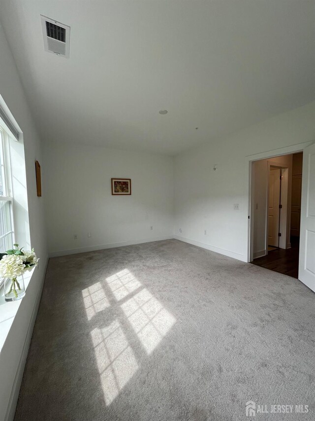 812 Stiller Ln, Monroe, NJ 08831 - empty room with dark colored carpet and baseboards