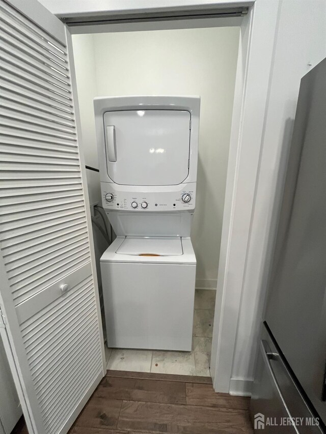 812 Stiller Ln, Monroe, NJ 08831 - laundry area with stacked washer / dryer and wood finished floors