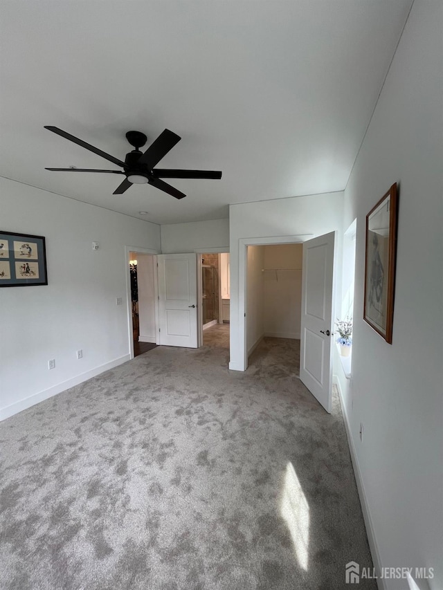 812 Stiller Ln, Monroe, NJ 08831 - unfurnished bedroom with a spacious closet, carpet, baseboards, and a ceiling fan