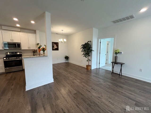 812 Stiller Ln, Monroe, NJ 08831 - kitchen featuring appliances with stainless steel finishes, a chandelier, dark wood finished floors, white cabinetry, and recessed lighting