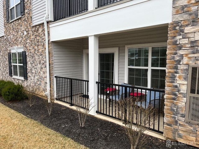 812 Stiller Ln, Monroe, NJ 08831 - view of exterior entry with stone siding and a balcony