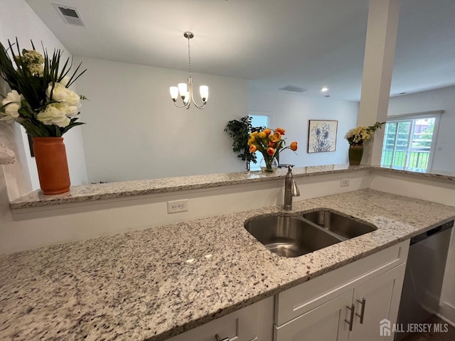 812 Stiller Ln, Monroe, NJ 08831 - kitchen with stainless steel dishwasher, a sink, white cabinetry, light stone countertops, and a chandelier