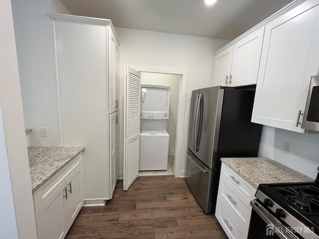812 Stiller Ln, Monroe, NJ 08831 - kitchen with stacked washer / dryer, stainless steel appliances, dark wood-style flooring, white cabinetry, and light stone countertops