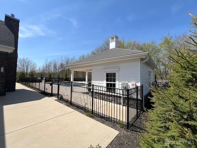 812 Stiller Ln, Monroe, NJ 08831 - view of side of property with a patio, a chimney, and roof with shingles