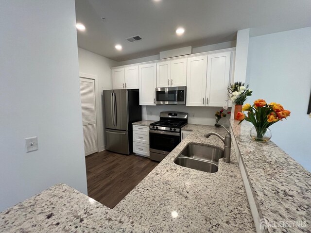 812 Stiller Ln, Monroe, NJ 08831 - kitchen featuring appliances with stainless steel finishes, a sink, light stone counters, white cabinetry, and recessed lighting