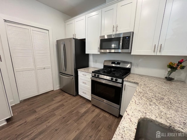 812 Stiller Ln, Monroe, NJ 08831 - kitchen with appliances with stainless steel finishes, dark wood finished floors, white cabinetry, and light stone countertops
