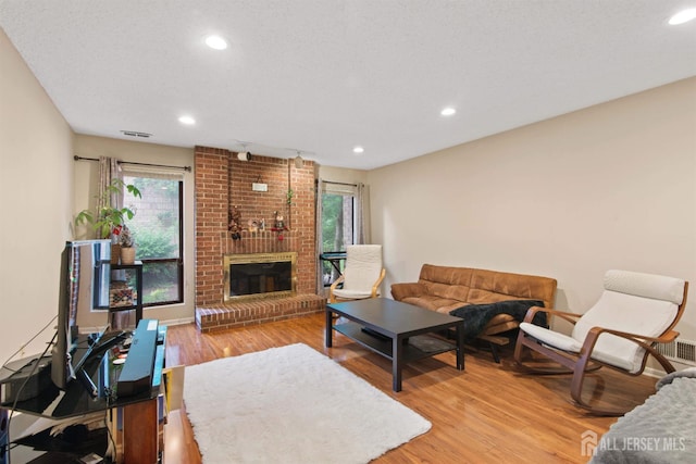 320 Willowbrook Dr, North Brunswick, NJ 08902 - living area with wood finished floors, recessed lighting, and a brick fireplace