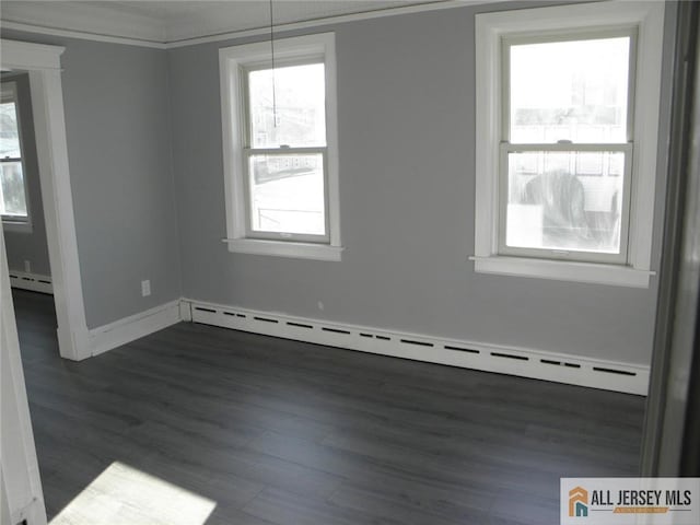 5 E Kupsch St, Sayreville, NJ 08872 - spare room with a baseboard heating unit, dark wood-type flooring, and baseboards