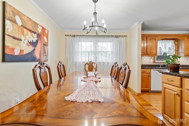 44 Pleasant Ave, Iselin, NJ 08830 - dining area with a chandelier, plenty of natural light, crown molding, and light wood-style floors