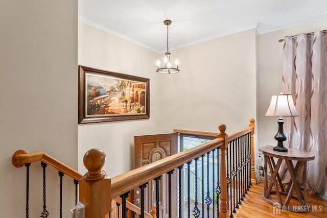 44 Pleasant Ave, Iselin, NJ 08830 - hall featuring an upstairs landing, a chandelier, wood finished floors, and crown molding