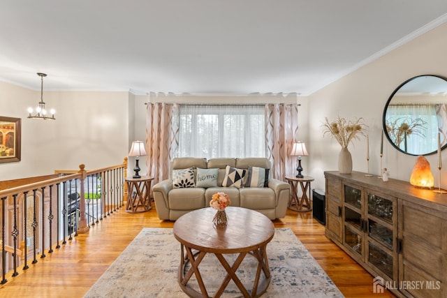 44 Pleasant Ave, Iselin, NJ 08830 - living room featuring plenty of natural light, crown molding, a chandelier, and light wood finished floors
